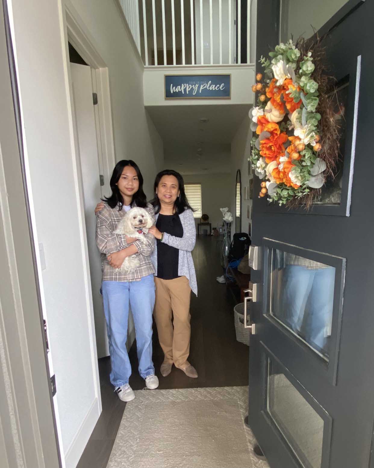 Mother and daughter in entry with family dog